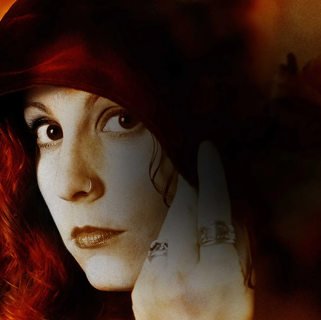 a woman holding her hand to her face